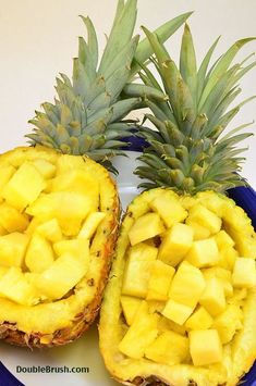 two pieces of pineapple sitting on top of a blue plate next to each other