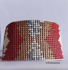 This boho-chic bracelet is handmade with Japanese Miyuki Delica beads using traditional looming techniques.These glass seed beads are known for their uniform cylinder shape, high quality and brilliance which became a world standard. This bracelet is very lightweight, glamorous and comfortable. you can mix and match them effortlessly with so many pieces in your wardrobe. The colors can be customized so feel free to contact me about them. It has a sliding knot so you can adjust it easily. The bracelet is 12.6 cm (4.96 in) long , 2.57 cm (1.01 in) wide Materials used: miyuki delica beads in opaque dyed maroon, metallic bronze, silk satin rustic gray , satin white ,nylbond beading threads, polyester lace threads Please handle with care. When you are not wearing it, store it separately. Take yo Red Bohemian Woven Beaded Bracelets, Red Bohemian Woven Bracelet, Handmade Red Bohemian Beaded Bracelets, Red Woven Beaded Bracelets For Festivals, Red Bohemian Handwoven Bracelets, Miyuki Bead, Boho Chic Bracelets, Artisan Bracelets, Loom Pattern