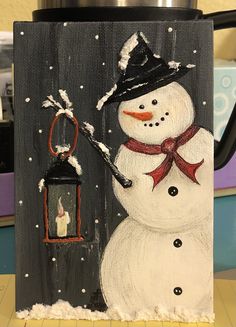 a painting of a snowman holding a lantern