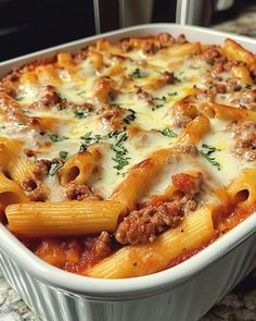 a casserole dish with meat and cheese in it sitting on a counter top