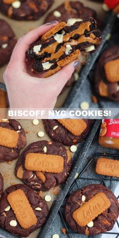 a person holding up a chocolate cookie with peanut butter on it and the words biscoff nyc cookies