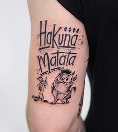 a man with a tattoo on his arm that says hakuna matata