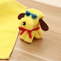 a yellow towel with a dog wearing sunglasses sitting on top of it next to a stuffed animal