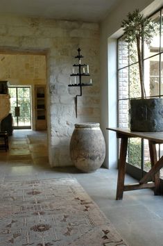 a large vase sitting in the middle of a room next to a table and chair