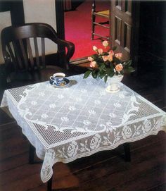 a table that has some flowers on it and a tea cup in front of it