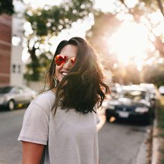 a woman with sunglasses on walking down the street