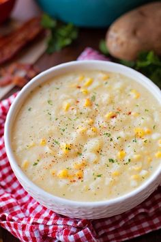 a white bowl filled with soup on top of a red and white checkered napkin