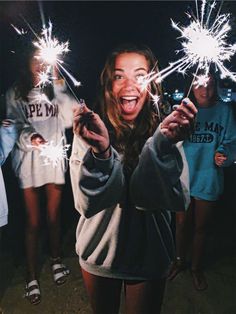 the girl is holding sparklers in her hands