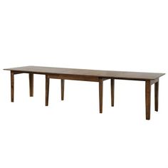 a wooden table sitting on top of a white floor