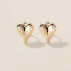 Heart goes padam padam in these hoops. Boo’s chubby heart motif, set on a 6mm huggie, are the sweetest addition to your ear stack. Minimal, sophisticated and chic, these shapely hoops will have hearts skipping beats. Created for you in the finest 14 karat gold, you'll want to wear these earrings always and never take them off, even when working out or in the shower. Elegant Heart Huggie Earrings For Everyday Wear, Valentine's Day Minimalist Huggie Earrings, Yellow Gold Heart Huggie Earrings, Elegant Huggie Earrings With Heart Charm, Elegant Double Heart Huggie Earrings With Heart Charm, Huggie Earrings With Heart Charm For Anniversary, Dainty Yellow Gold Huggie Heart Earrings, Padam Padam, Huggie Earrings Gold