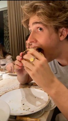 a man sitting at a table eating food