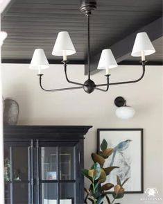 a chandelier hanging over a dining room table