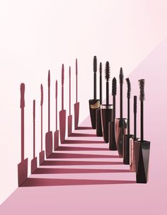 there are many different types of mascaras lined up in the same row on pink background