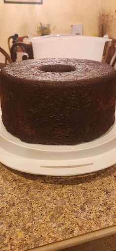 a chocolate cake sitting on top of a white plate