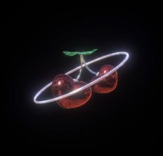 two cherries in the shape of saturn against a black background