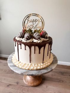 a birthday cake with chocolate and strawberries on top