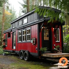 a red and black tiny house in the woods