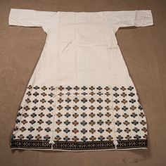 This is a never-used Vintage , hand embroidered on a hand woven cotton background dress, from Turkey. There is no neck oppening so it seems to have never been used but still we got the dress professionally cleaned since cotton gets somehow stained on its own in a chest. The embroidered part is the back and the front has no embroidery since they are supposed to wear an embroidered apron on the front.  It is a pure cotton , all hand made item with age therefore it is not in brand new condition. Sl Fitted Cotton Dresses With Traditional Patterns, Folk Style Cotton Dress With Traditional Patterns, Fitted Long Sleeve Dresses With Motifs, Traditional Embroidered Cotton Dress, Traditional Cotton Embroidered Dress With Traditional Patterns, Cotton Dresses With Traditional Embroidered Patterns, Cotton Dresses With Multicolor Embroidery And Traditional Patterns, Short Sleeve Cotton Kurta With Floral Embroidery, Cotton Kurta With Floral Embroidery And Short Sleeve