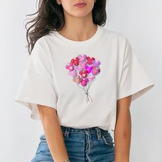 a woman wearing a white t - shirt with pink and red balloons on it's chest