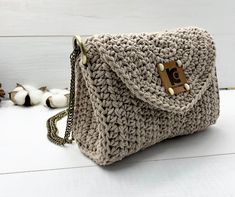 a crocheted purse sitting on top of a white table