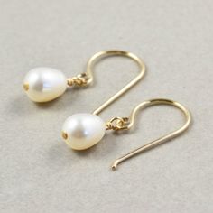 "White pearl earrings. Gold filled earrings featuring lustrous 7mm white freshwater teardrop shaped pearls handpicked to match as perfect as possible. They hang from handcrafted gold filled ear wires I created especially for these pearls. Perfect for everyday wear! Length from top of ear wire is slightly under 1\". Variations of these earrings are: 1. Gold filled 2. Sterling silver 3. Oxidized sterling silver During checkout you will be able to select which option above you would like. Complimen Earrings Handmade Silver, Pearl Earrings Handmade, Pearl Earrings Gold, White Pearl Earrings, White Pearl Earring, June Birthstone Jewelry, Jewelry White, Gold Filled Earrings, June Birthstone