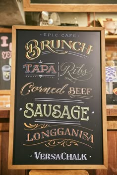 the menu for brunch and tapa is displayed on a blackboard