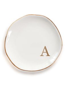 a white and gold plate with the letter a on it