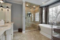 a bath room with a tub a sink and a window