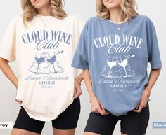 two women standing next to each other wearing t - shirts that say cloud wine club