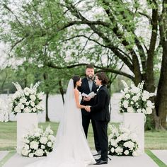 a bride and groom standing in front of an altar