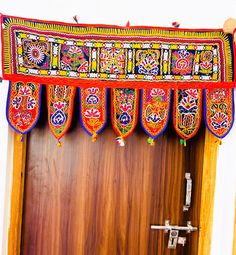 the door is decorated with colorful designs on it's sides and hanging from the ceiling