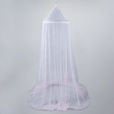 a white bed with a mosquito net hanging from it's head and bottom end