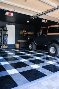 a black and white checkered garage with a jeep