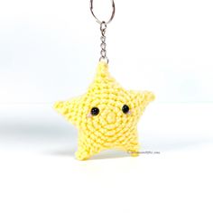 a crocheted yellow star keychain with black eyes