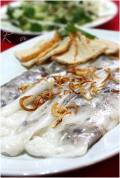 a white plate topped with fish covered in sauce