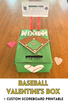 this baseball valentine's box is made from cardboard and has hearts on the table