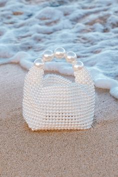 The luxe vibes will be off the charts when you pair your bougiest looks with the Lulus Upgraded Glam White Pearl Handbag! This iconic bag is composed of faux pearl beads that shape a bucket-like body with a flat bottom and a folding top. The interior pocket has plenty of space for all your chicest essentials, and oversized faux pearls form the handle that lends a stunning finish to this statement-making bag. Unlined. 100% ResinWipe With Damp Cloth When Soiled. Imported. Lulus | Upgraded Glam Whi Pearl Handbag, Classic Purse, Lulu Fashion, Cute Handbags, Purse Styles, Iconic Bags, Money Bag, Love Blue, Chic Handbags