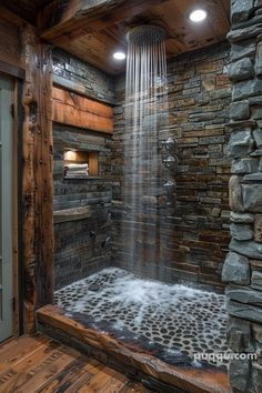 a bathroom with a stone shower and wood flooring on the walls is pictured in this image