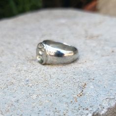 This signet ring is cast in lead-free pewter (Britannia alloy). The ring size when cast is 6.25. The sealing image is a gourd. Celestial drinking gourd. A natural/cultivated fruiting body from a vine historically used to carry beverages. This ability to help carry precious life-giving water has given the gourd special significance. This is part of a series of signet rings I am making cast from lead-free pewter. Each ring is hand sculpted to give a unique, rustic style, relief image when used as Symbolic Round Hand Cast Signet Ring, Vintage Hand Cast Signet Ring As Gift, Vintage Hand-cast Round Signet Ring, Vintage Hand Cast Round Signet Ring, Vintage Hand Cast Sterling Silver Signet Ring, Hand Cast Signet Ring As Gift, Stamped Silver Signet Promise Ring, Silver Stamped Signet Ring For Promise, Hand-cast Silver Signet Ring