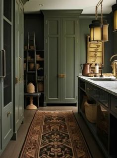 an image of a kitchen with green cabinets and rugs on the floor in front of it