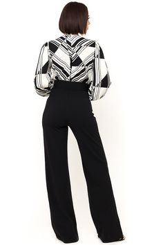 The Black and White Jumpsuit by Bella Chic is the total package, elegant, classic, and stunning! You’ll look completely irresistible in this one piece outfit. Go from career to cocktails in this long sleeve jumpsuit! This black and white jumpsuit starts with a v neck design and a fitted waist top that flows into relaxed wide leg pants, while a waist cinching belt completes this look! This jumpsuit is made of a stretch knit fabric that shapes and hugs your curves. The black and white jumpsuit is Black And White Jumpsuit, Black White Jumpsuit, V Neck Design, One Piece Outfit, White Jumpsuit, Long Sleeve Jumpsuit, Black Jumpsuit, Cinched Waist, Neck Designs