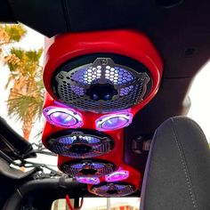 the interior of a vehicle with speakers on it's headrests and lights