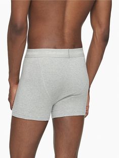 A Calvin Klein icon. The essential designer trunk reinvented in extra-soft cotton stretch. Made with wicking to keep you cool and dry. Designed with the original Calvin Klein logo waistband, this is a sporty look that feels sexy everyday. With a supportive pouch and more coverage than our hip brief, this style is easy under anything.  Material: 95% Cotton, 5% Spandex. Calvin Klein Stretch Solid Color Boxer Briefs, Calvin Klein Solid Color Sports Boxer Briefs, Calvin Klein Black Cotton Boxer Briefs, Calvin Klein Black Multi-pack Boxer Briefs, Calvin Klein Cotton Boxer Briefs Multi-pack, Sporty Look, Keep Your Cool, Trunk, Calvin Klein