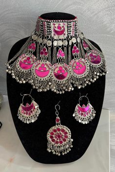 Exquisite Afghan Jewelry Set - Perfect for Special Occasions🇦🇫 Add a touch of exotic elegance to your look with our stunning Afghan jewelry set. Handcrafted by skilled artisans, each piece is a unique work of art that captures the rich cultural heritage of Afghanistan. This set includes a dazzling necklace, matching earrings, and a Tikka headpiece, all intricately designed with traditional Afghan motifs and embellished with vibrant gemstones. Traditional Handmade Pink Jewelry Sets, Handmade Pink Jewelry For Festivals, Traditional Pink Jewelry For Ceremonial Occasions, Unique Pink Jewelry For Festivals, Pink Temple Jewelry For Ceremonial Occasions, Pink Ceremonial Temple Jewelry, Unique Festival Jewelry, Pink Jewelry For Ceremonial Festivals, Pink Jewelry For Ceremonial Festival Occasions