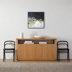 two chairs are sitting in front of a table with a bowl on top of it