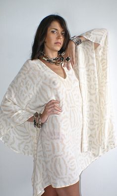 Lovely beige and cream designer tribal print silk Kaftan A perfect soft floaty addition to your summer wardrobe!  I manufactured this unique silk printed cover up for Nuove- Onde. Looks fantastic day or night with your favourite accessories or worn over jeans.  A versatile piece day or night.♥️ Please message me if you have any questions. White Printed V-neck Kaftan, Cream Kaftan For Spring Vacation, Flowy Beige Kaftan For Summer, Beige Flowy Kaftan For Summer, Summer Beige Flowy Kaftan, Spring Vacation Cream Kaftan, Cream Kaftan For Spring Beach Occasions, Elegant Beige Kaftan For Vacation, Cream Long Sleeve Kaftan For Summer