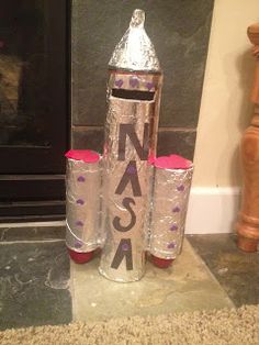 two cans are wrapped in tin foil with the word sasa on them sitting next to a fireplace