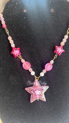 A handmade charm necklace that makes a perfect star-powered statement piece! The necklace is perfect for any concert, outing, or everyday wear! Necklace is 11 inches length wise! Party Star Charm Necklaces, Pink Star Charm Pendant Jewelry, Star Charm Necklace For Festivals, Handmade Star Necklaces For Party, Trendy Pink Necklace With Star Charm, Party Necklaces With Star Charm, Party Necklace With Star Charm, Trendy Handmade Star-shaped Necklaces, Trendy Handmade Star-shaped Necklace