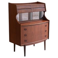 a wooden cabinet with glass doors on the top and bottom drawers, against a white background