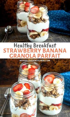 four jars filled with granola parfait on top of a wooden table